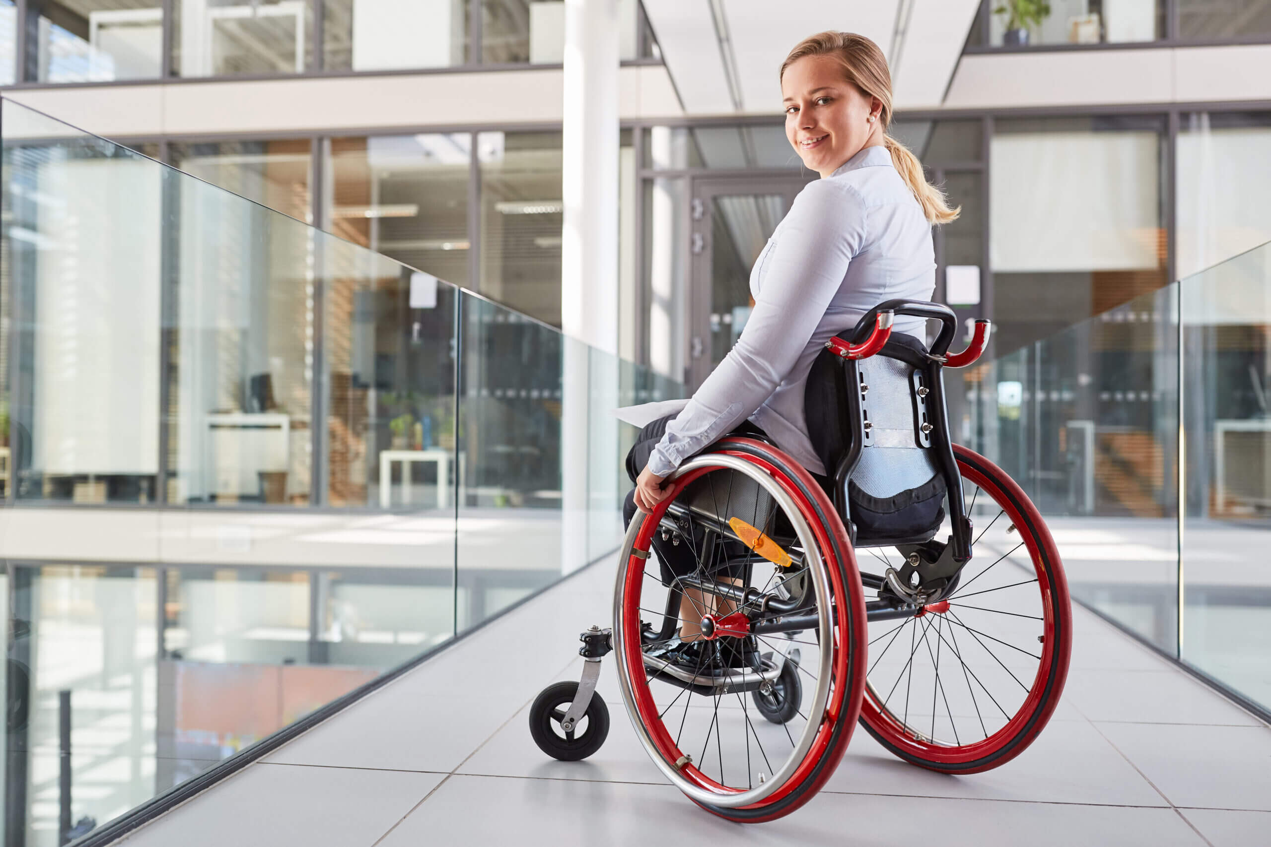 Smiling,Young,Woman,In,Wheelchair,In,Business,Company,For,Inclusion